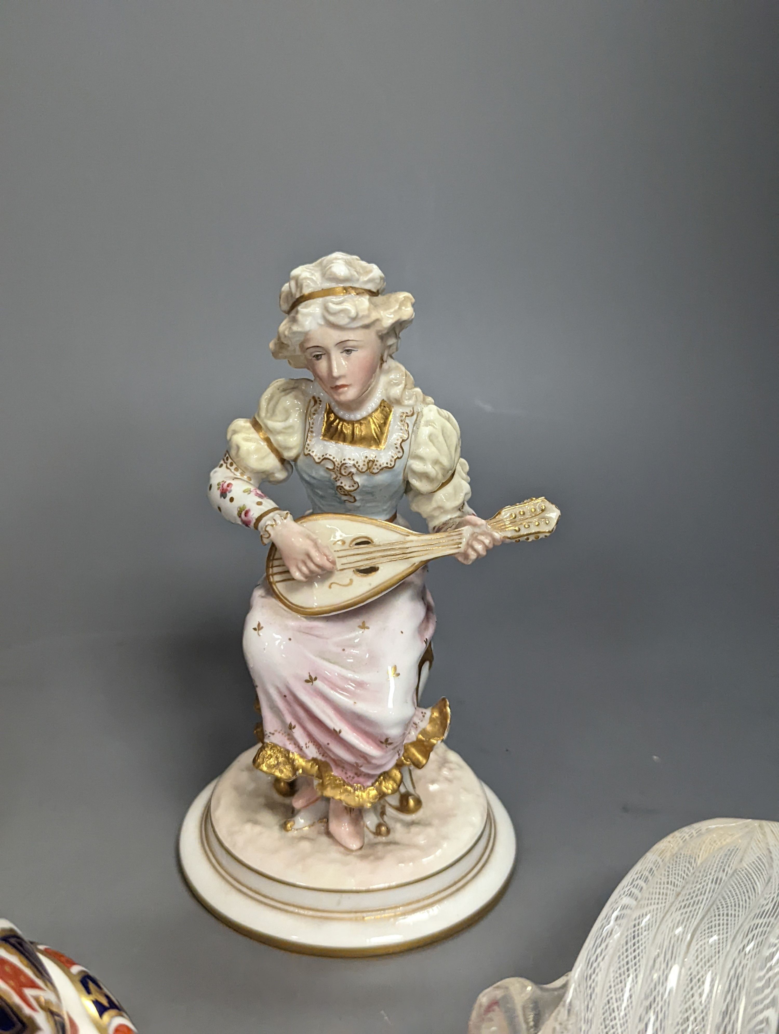 A pair of Royal Crown Derby figures of musicians, c.1905, 15cm, two similar animal paperweights and a Latticino glass slipper, tallest being the dragon 11cm